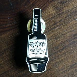 Amaro Montenegro lapel pin. New. 1885